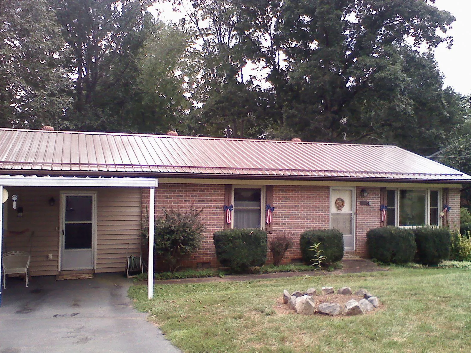 Bronze metal roof and carport on a brick ranch home in Lenoir
