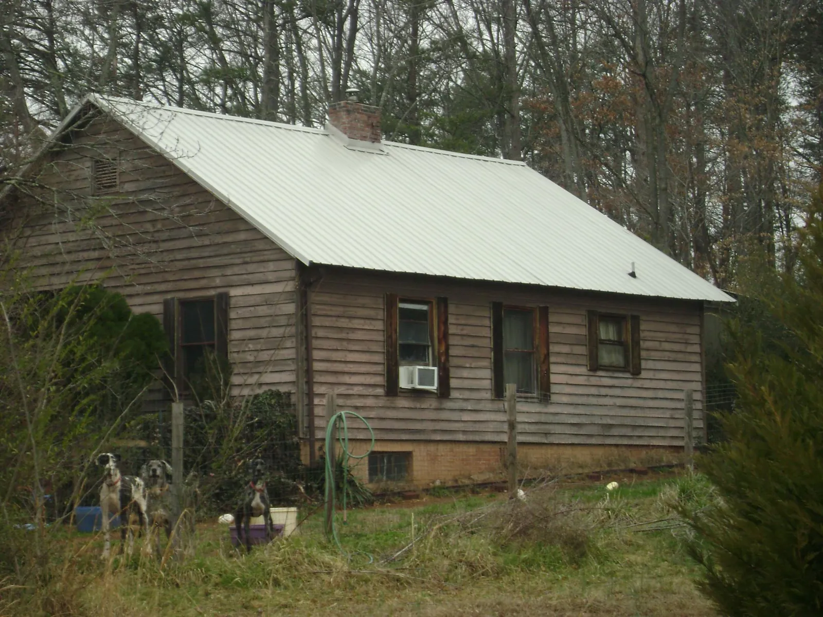 White metal roof on an old wood sided farmhouse, from a Metal Roof Installation job in Lenoir